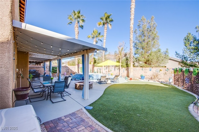 view of yard with a fire pit and a patio area