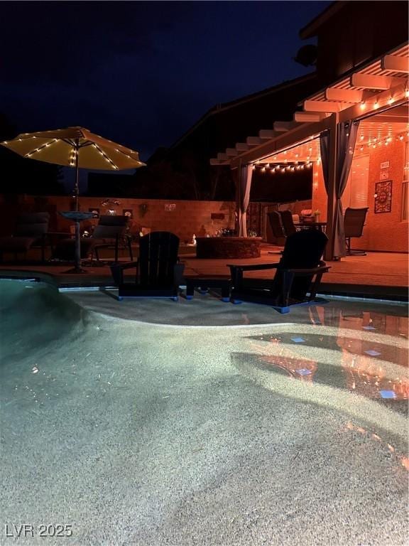 patio at twilight with a swimming pool