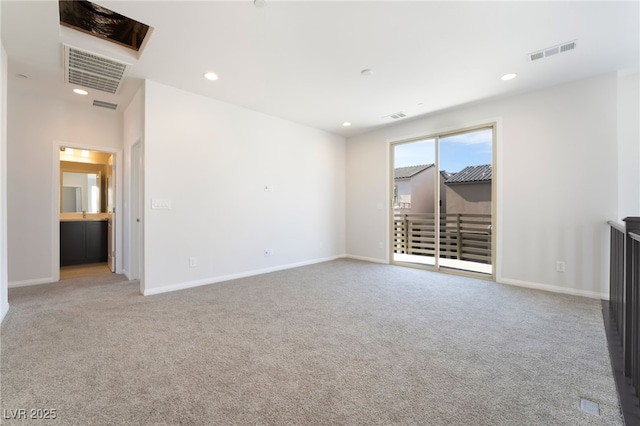 unfurnished living room featuring light carpet