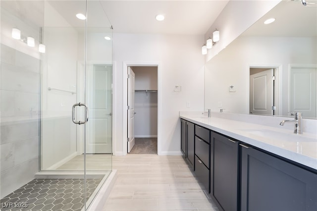 bathroom featuring vanity and a shower with shower door