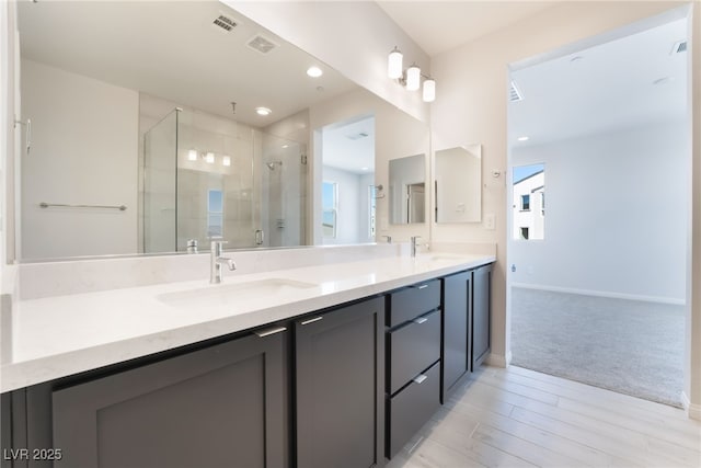 bathroom with vanity and an enclosed shower