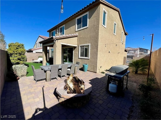 back of house with a patio area and a fire pit