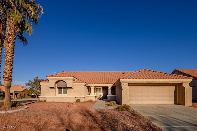 mediterranean / spanish-style home with a garage