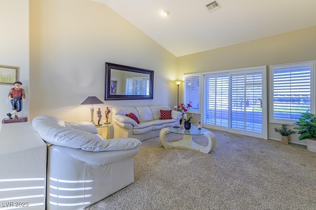 living room with carpet floors and high vaulted ceiling