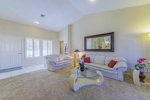 carpeted living room featuring vaulted ceiling