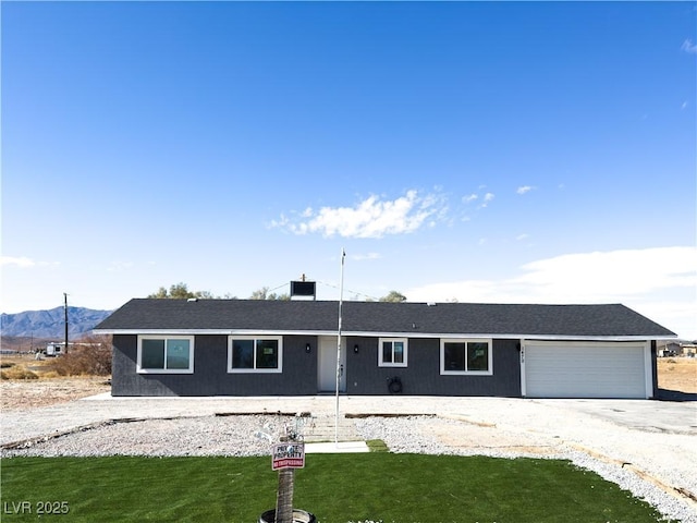 ranch-style house with a garage and a front lawn