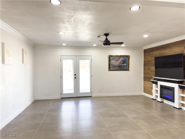 unfurnished living room featuring ornamental molding, french doors, ceiling fan, and light tile patterned flooring