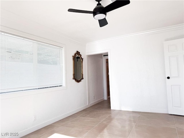 unfurnished room with light tile patterned flooring, ceiling fan, and ornamental molding