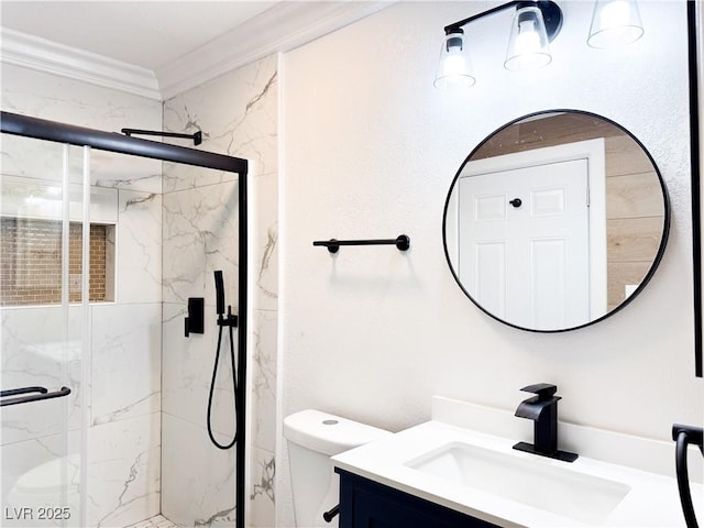 bathroom featuring ornamental molding, toilet, a shower with shower door, and vanity