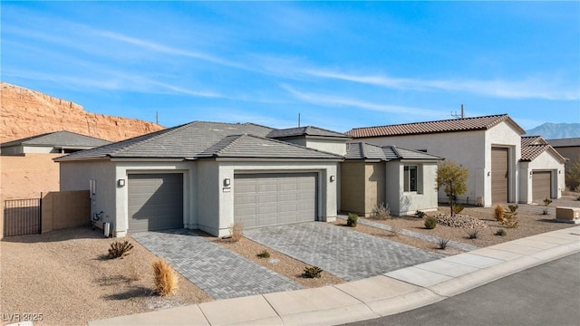 view of front of property featuring a garage and a mountain view