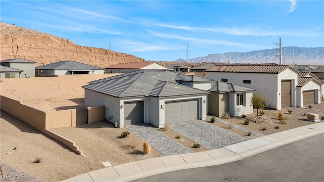 view of front of property with a garage and a mountain view