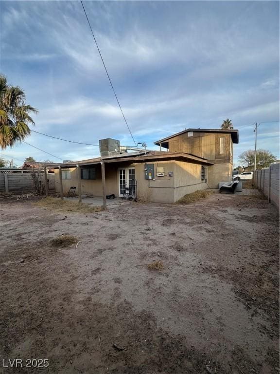 back of property featuring central AC unit