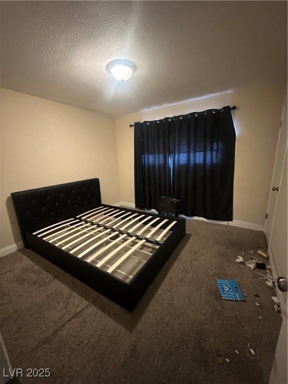 carpeted bedroom featuring baseboards and a textured ceiling