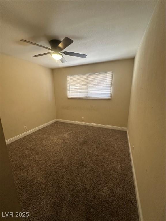 empty room featuring ceiling fan, carpet flooring, and baseboards