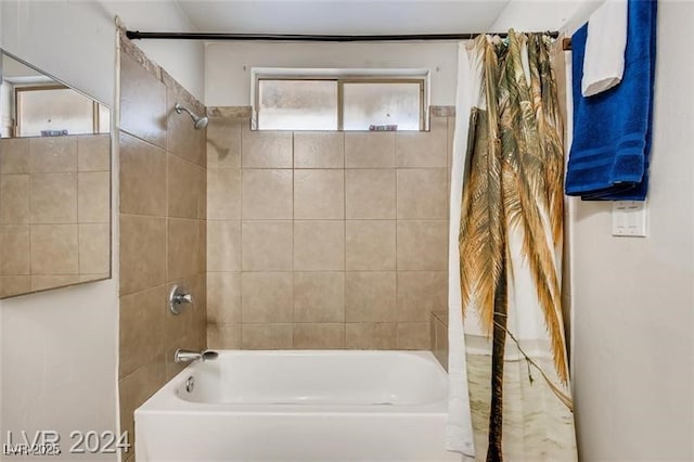 bathroom with shower / bath combo with shower curtain