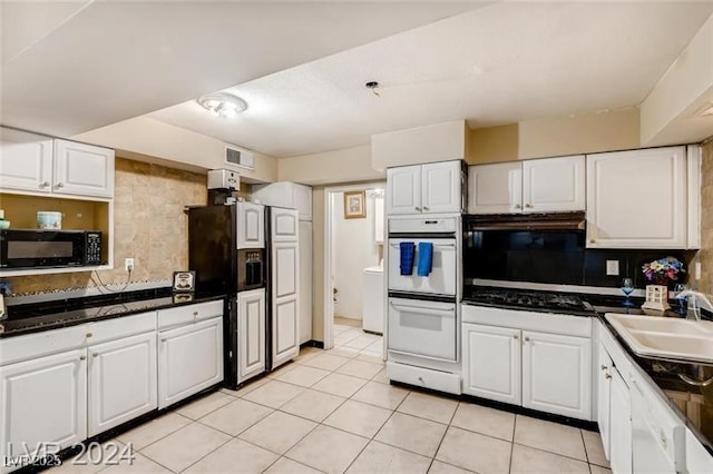 kitchen with white cabinetry and black appliances