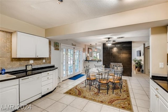 kitchen with white cabinets, decorative backsplash, light tile patterned floors, white dishwasher, and french doors