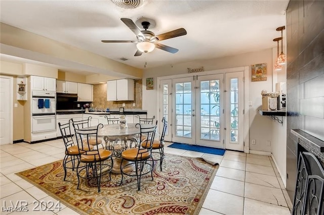 tiled dining space featuring french doors and ceiling fan