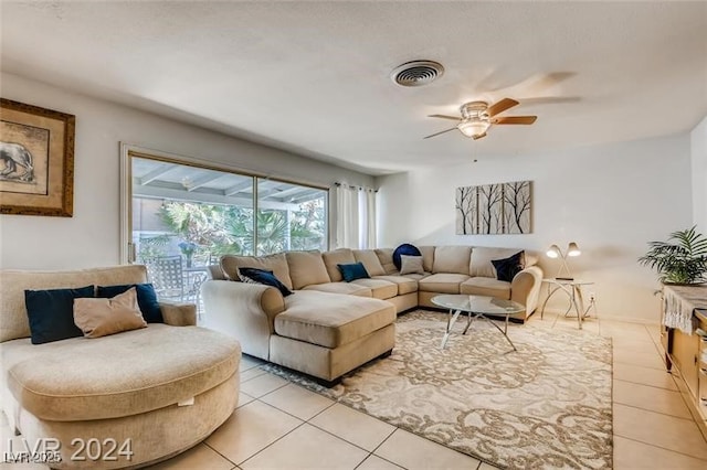 tiled living room with ceiling fan