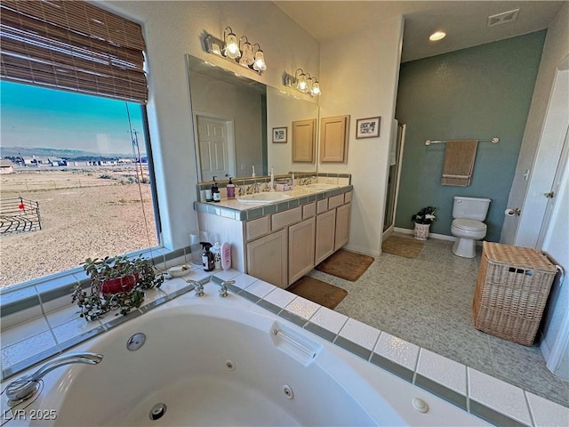 full bathroom featuring vanity, shower with separate bathtub, and toilet