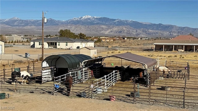 view of horse barn with a mountain view