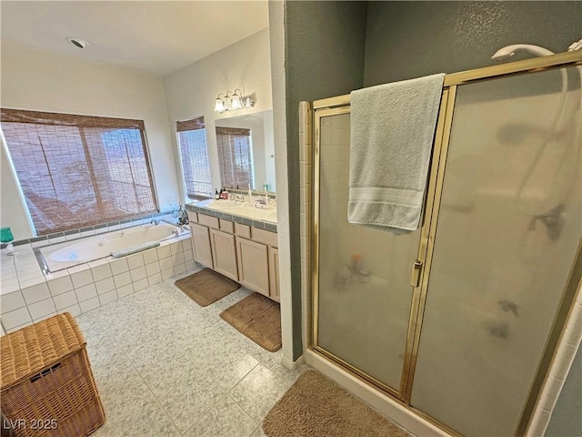 bathroom with vanity and separate shower and tub