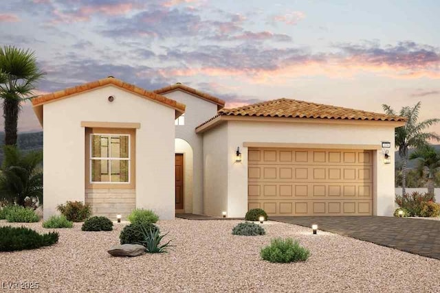 mediterranean / spanish-style house with a garage