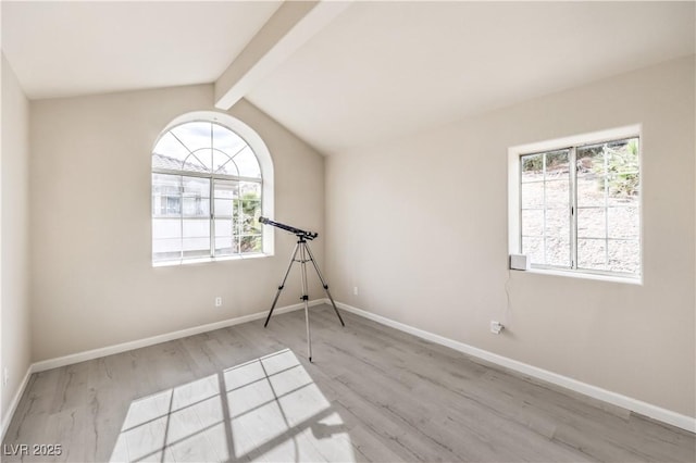 empty room with vaulted ceiling with beams and light wood-type flooring