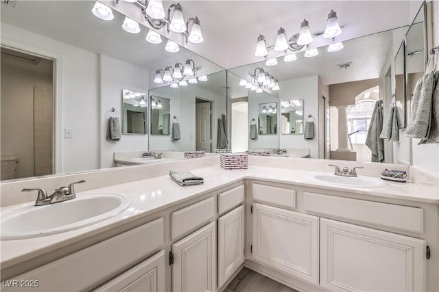 bathroom featuring ornate columns and vanity