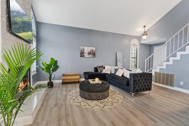 living room featuring hardwood / wood-style flooring and lofted ceiling