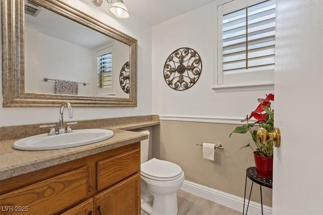 bathroom featuring hardwood / wood-style flooring, vanity, and toilet