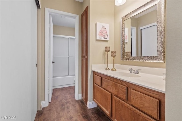 bathroom featuring vanity, wood-type flooring, and walk in shower