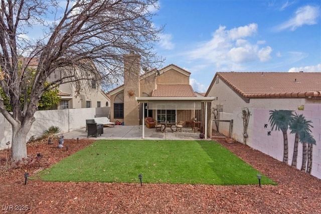 rear view of property with a patio area and a lawn