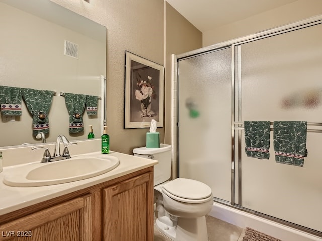 3055 Key Largo Dr Unit 203, Las Vegas, NV 89120 - full bath with a stall shower, vanity, toilet, and tile patterned flooring