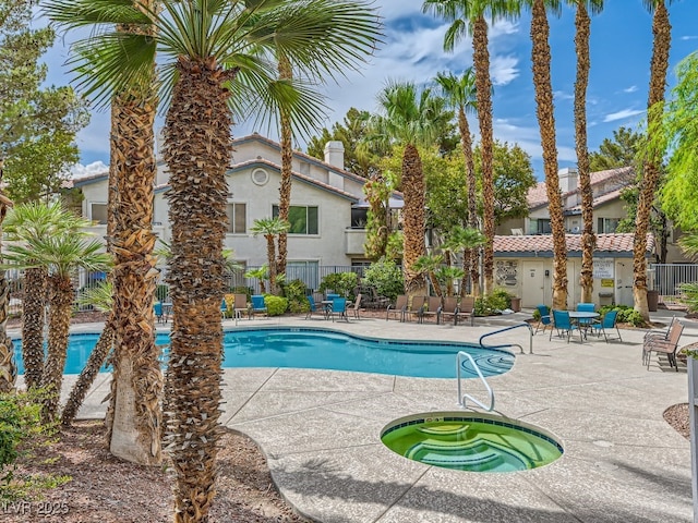 view of swimming pool with a hot tub and a patio