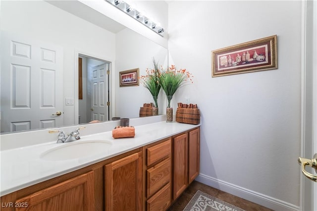 bathroom featuring baseboards and vanity