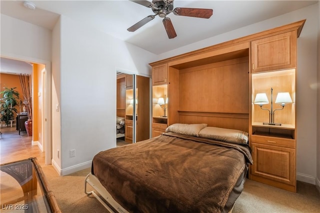 bedroom featuring ceiling fan, baseboards, a closet, and light colored carpet