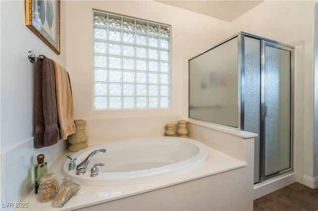 full bathroom with a garden tub and a shower stall