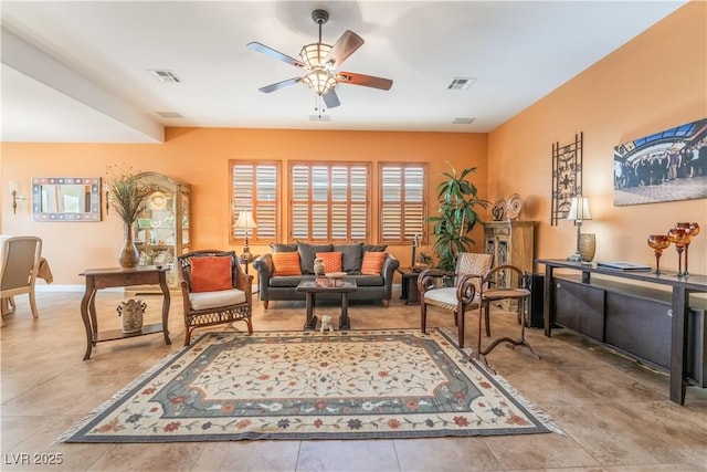 sitting room featuring baseboards, visible vents, and a ceiling fan