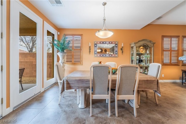 dining area with tile patterned floors, visible vents, and baseboards