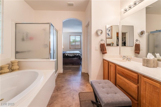 full bathroom with a garden tub, connected bathroom, vanity, visible vents, and a stall shower