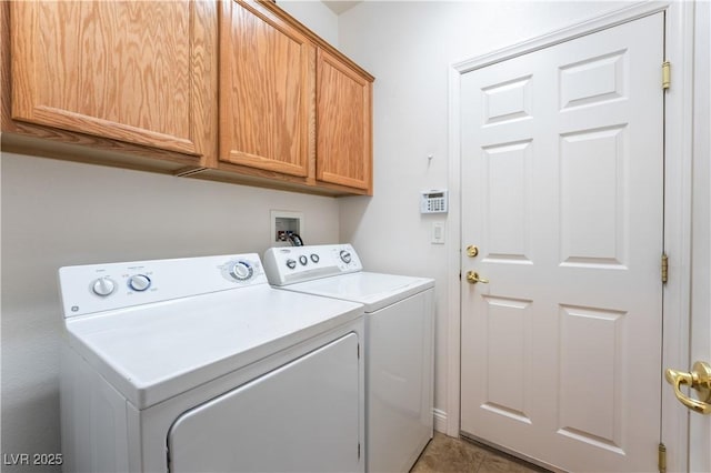 washroom with washing machine and dryer and cabinet space