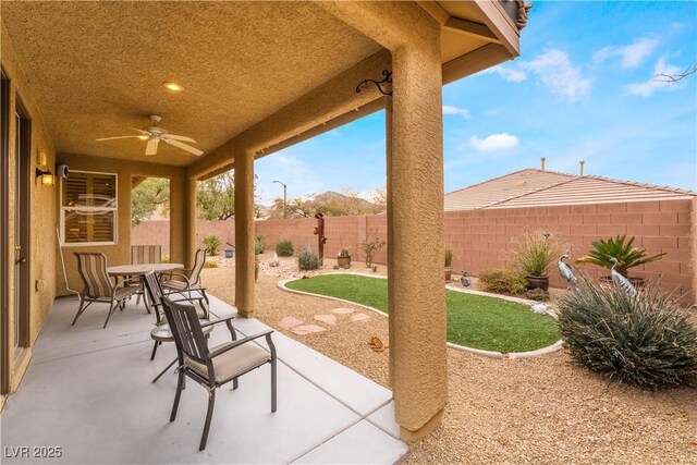 view of patio / terrace with a ceiling fan, outdoor dining area, and a fenced backyard