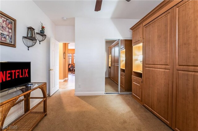 hall with light carpet and baseboards