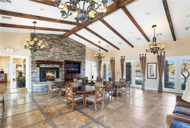 dining room with a chandelier, high vaulted ceiling, visible vents, and baseboards