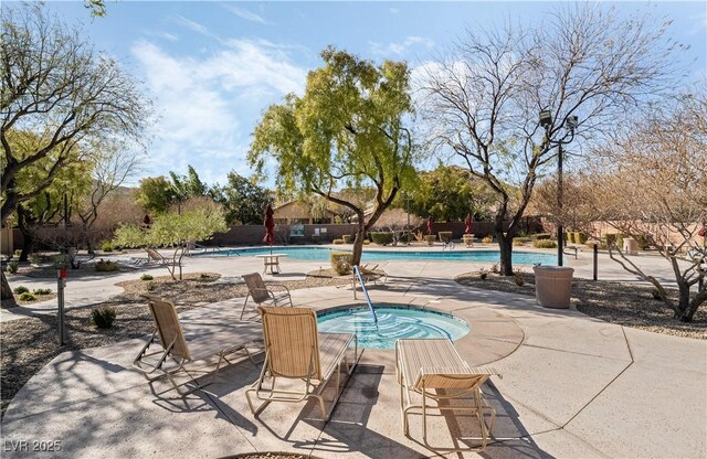 community pool featuring a community hot tub and a patio