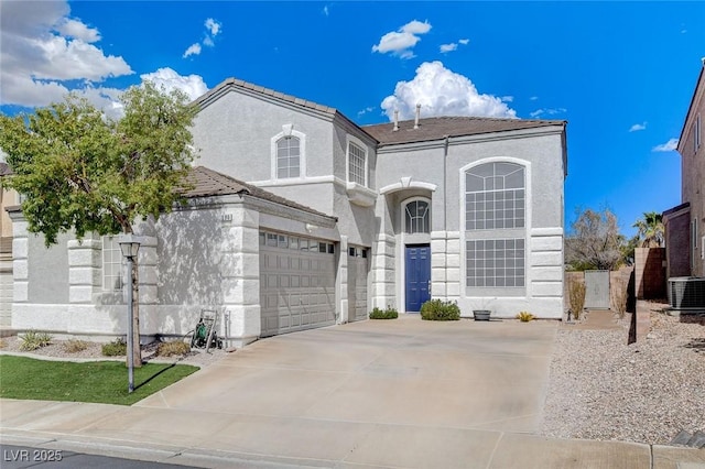 view of front property with a garage and central AC