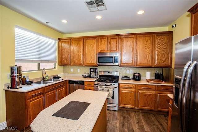 kitchen with stainless steel appliances, tasteful backsplash, sink, and dark wood-type flooring