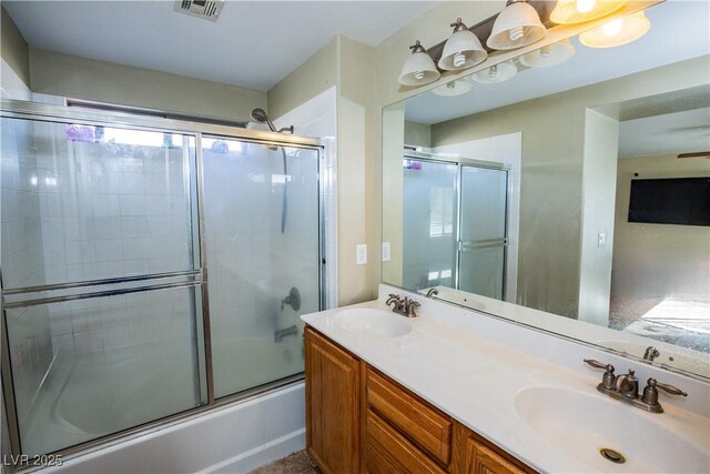 bathroom featuring enclosed tub / shower combo and vanity