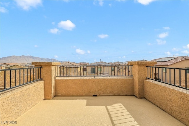 view of patio / terrace with a balcony and a mountain view